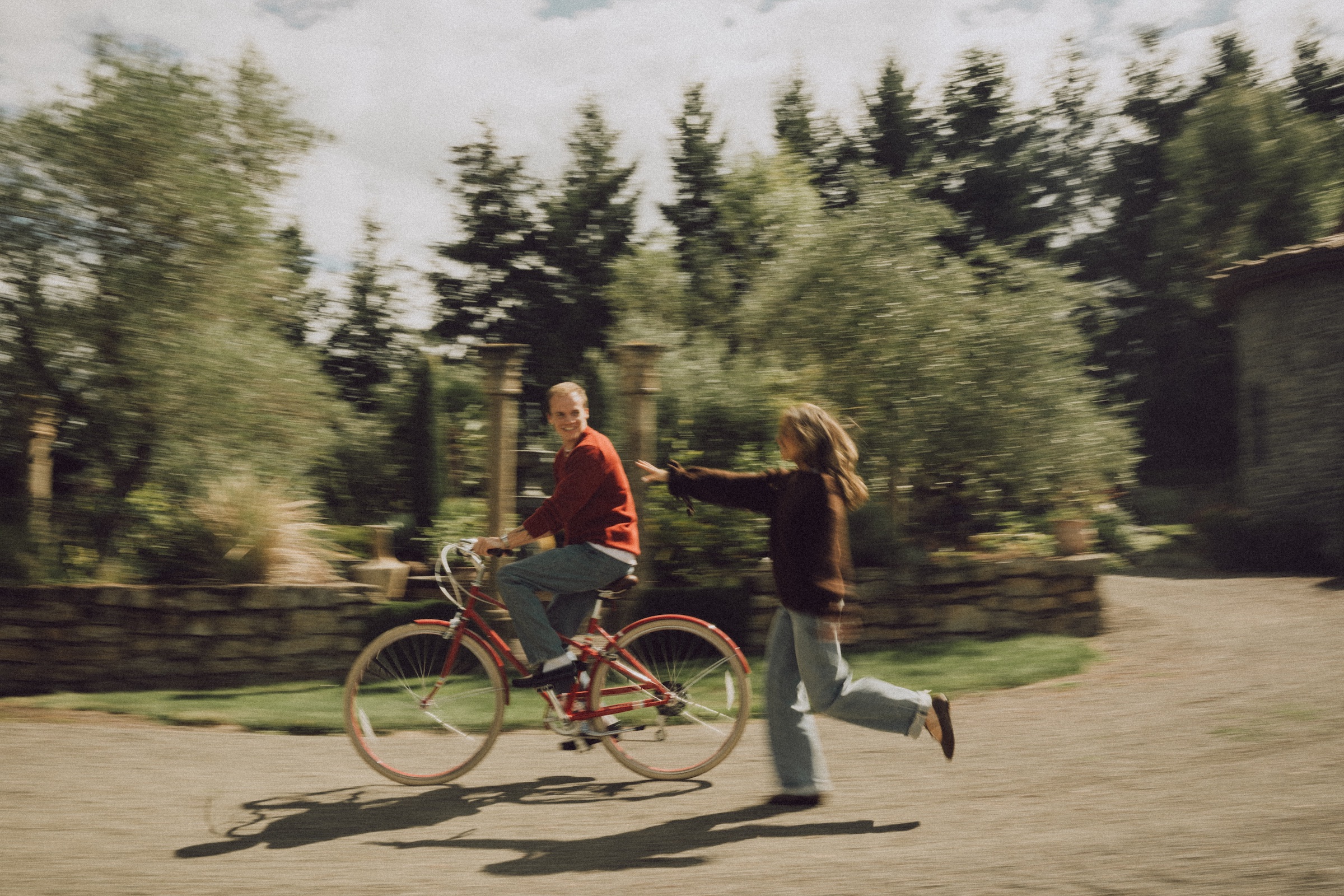 A couple enjoys a playful moment together outdoors, photographed by Chloe.